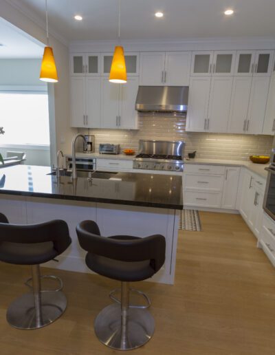 Modern kitchen interior with a breakfast bar and stainless steel appliances.
