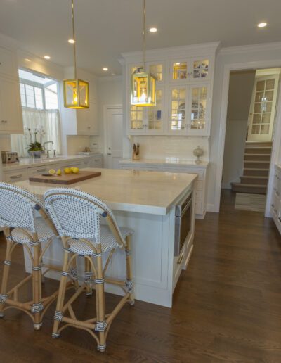 Spacious modern kitchen interior with white cabinetry and a central island.
